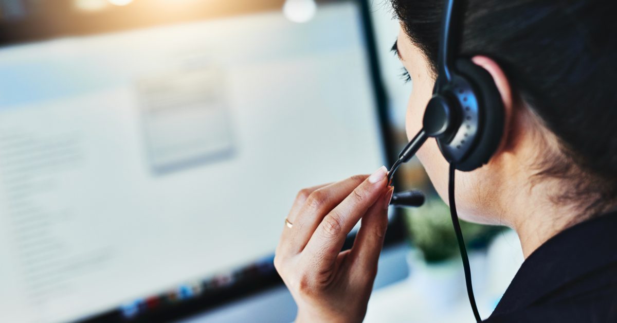 Rearview shot of a young woman working in a call centre